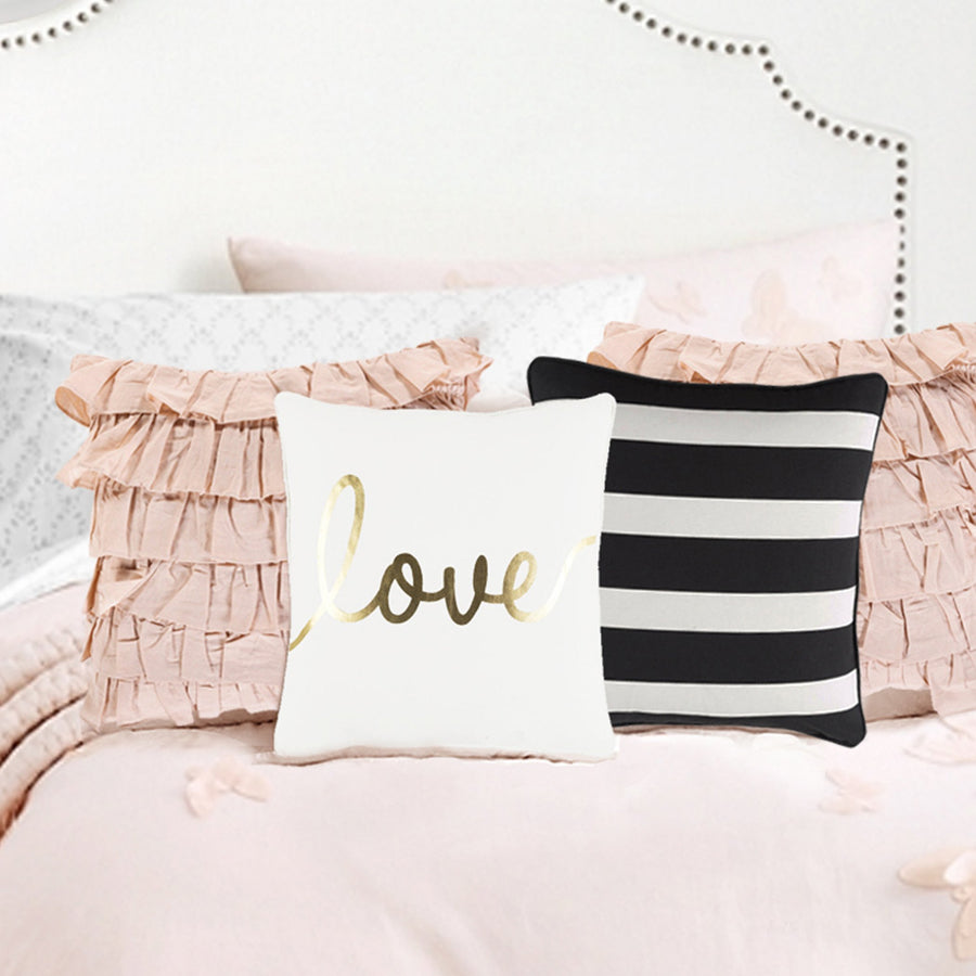 black and white striped pillow, light pink pillows, and white love pillow for bedroom